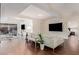 Spacious living room with white sectional sofa, wood floors, and access to the bedroom at 7151 E Rancho Vista Dr # 4001, Scottsdale, AZ 85251
