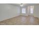 Living area with tile flooring, a ceiling fan, and windows with blinds at 7431 W Ocotillo Rd, Glendale, AZ 85303