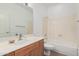 Bathroom with oak vanity, shower/tub combo, and large mirror at 808 N Williams Cir, Mesa, AZ 85203