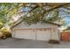 Front exterior of a two-story house with a two-car garage and white facade, shaded by a tree at 808 N Williams Cir, Mesa, AZ 85203