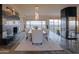 Elegant dining room with a modern chandelier, fireplace, and desert views at 8702 E Silver Saddle Dr, Carefree, AZ 85377