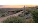 Long driveway leading to a beautiful desert home at sunset at 8702 E Silver Saddle Dr, Carefree, AZ 85377