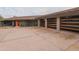 Front view of a contemporary home with glass garage doors and a unique entry at 8702 E Silver Saddle Dr, Carefree, AZ 85377