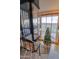 Modern foyer with a glass elevator, curved staircase, and a festive Christmas tree at 8702 E Silver Saddle Dr, Carefree, AZ 85377