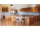 Modern kitchen with marble countertops, wood cabinets, and an island with bar seating at 8702 E Silver Saddle Dr, Carefree, AZ 85377