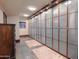 Spacious walk-in closet with frosted glass doors and custom built-in shelving at 8702 E Silver Saddle Dr, Carefree, AZ 85377
