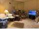 Living Room with carpeted floor, TV, and assorted furniture at 10502 W Hutton Dr, Sun City, AZ 85351