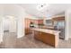 Spacious kitchen with island, stainless steel appliances, and wood cabinets at 13992 W Maui Ln, Surprise, AZ 85379