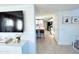 View of white kitchen from living area, with island and tile floor at 1735 S Balboa Dr, Gilbert, AZ 85295