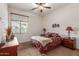 Comfortable bedroom with ceiling fan, wooden furniture, and carpeted flooring at 17907 W Udall Dr, Surprise, AZ 85374