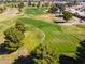 Aerial view of a golf course with fairways, greens, and surrounding homes at 17907 W Udall Dr, Surprise, AZ 85374