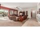 Open concept living room featuring a ceiling fan, large windows, and sliding glass door to the backyard at 17907 W Udall Dr, Surprise, AZ 85374