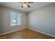 Well-lit bedroom featuring wood floors and a window with blinds at 2201 W Wickieup Ln, Phoenix, AZ 85027