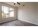 Bedroom with a large window offering ample natural light and wood-look flooring at 26435 N 44Th Way, Phoenix, AZ 85050