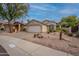 Exterior view of a single-story home with a two-car garage and desert landscaping at 26435 N 44Th Way, Phoenix, AZ 85050