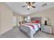 Main bedroom with ceiling fan, plush carpet, and ensuite bathroom access at 2727 N Price Rd # 6, Chandler, AZ 85224