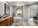 Spa-like bathroom with soaking tub and granite vanity at 28990 N White Feather Ln # 127, Scottsdale, AZ 85262