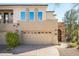 Two-story home with attached two-car garage and arched entryway at 28990 N White Feather Ln # 127, Scottsdale, AZ 85262