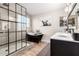 Spacious bathroom with black accents, glass shower, and freestanding tub at 3504 W Tanner Ranch Rd, San Tan Valley, AZ 85144