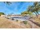 Community basketball court surrounded by grass and trees at 43202 W Delia Blvd, Maricopa, AZ 85138