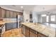 Kitchen featuring dark wood cabinetry, stainless steel appliances, and tile countertops and flooring at 43202 W Delia Blvd, Maricopa, AZ 85138