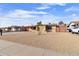 Street view of a single-story home with a small tree in the gravel yard at 5620 N 71St Ave, Glendale, AZ 85303