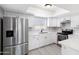 Bright, updated kitchen with white shaker cabinets, stainless steel appliances, and quartz counters at 5620 N 71St Ave, Glendale, AZ 85303