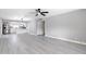 Living area with gray walls, white trim, and wood-style flooring, open to the kitchen at 5620 N 71St Ave, Glendale, AZ 85303