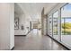 Bright hallway in the clubhouse with tile flooring, large windows, and modern artwork at 5807 E Rose Garden Ln, Phoenix, AZ 85054