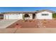 Front yard with desert landscaping, a double garage, and a decorative entryway at 6424 E Dallas St, Mesa, AZ 85205