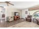 Living room with wood floors, ceiling fan, area rug, and comfortable seating at 6424 E Dallas St, Mesa, AZ 85205