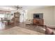 Living room with wood floors, ceiling fan, and view of the dining area at 6424 E Dallas St, Mesa, AZ 85205