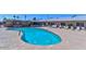 Community pool with lounge chairs at 6424 E Dallas St, Mesa, AZ 85205