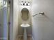 Powder room with pedestal sink and oval mirror at 8022 S 48Th Dr Dr, Laveen, AZ 85339