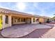 Spacious backyard patio with flagstone pavers, surrounded by desert landscaping and a tile roof at 8450 W Mcrae Way, Peoria, AZ 85382