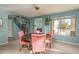 Dining area adjacent to the foyer, featuring a round table and ample natural light at 912 N 164Th Dr, Goodyear, AZ 85338