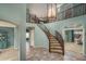 Grand foyer with a curved staircase, chandelier, and tile flooring at 912 N 164Th Dr, Goodyear, AZ 85338