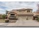 Two-story home with a three-car garage, landscaped front yard, and stone accents at 912 N 164Th Dr, Goodyear, AZ 85338