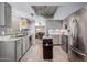 Modern kitchen with stainless steel appliances and gray cabinets at 9437 W Mcrae Way, Peoria, AZ 85382