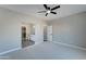 Primary bedroom with ceiling fan and access to en-suite bathroom at 9458 W Concordia Dr, Arizona City, AZ 85123