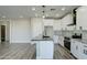 Bright kitchen with white cabinets, granite countertops, and an island at 9458 W Concordia Dr, Arizona City, AZ 85123