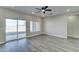 Living room with vinyl plank flooring and sliding glass door to patio at 9458 W Concordia Dr, Arizona City, AZ 85123