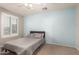 Light and airy bedroom with a full-size bed and light blue accent wall at 9982 W Villa Chula --, Peoria, AZ 85383