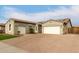 Two-car garage and paved driveway with a lush green lawn at 9982 W Villa Chula --, Peoria, AZ 85383