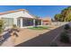 Artificial turf and sand backyard with a screened patio at 10705 E Champagne Dr, Sun Lakes, AZ 85248