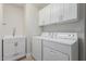 Laundry room with washer, dryer, cabinets, and a sink at 10705 E Champagne Dr, Sun Lakes, AZ 85248