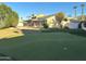 Backyard with putting green, swimming pool, and surrounding trees at 11808 N 111Th Way, Scottsdale, AZ 85259