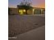 House exterior at dusk featuring a two-car garage and desert landscaping at 1231 E Marco Polo Rd, Phoenix, AZ 85024