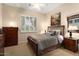 Cozy bedroom with wooden furniture, ceiling fan, and plantation shutters at 12350 W Bajada Rd, Peoria, AZ 85383