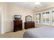 Bedroom with bed, dresser, mirror, and windows with shutters at 12350 W Bajada Rd, Peoria, AZ 85383